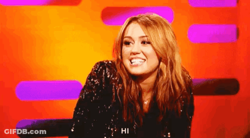 A Woman In A Sequined Top Says Hi GIF