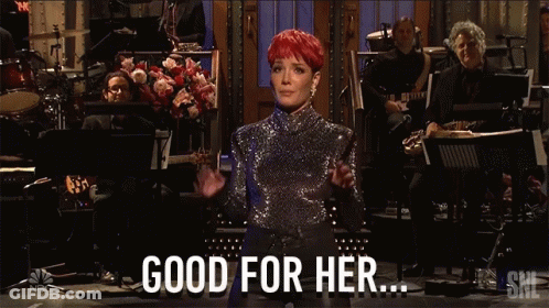 A Woman In A Sequined Top Stands In Front Of An Orchestra And Says " Good For Her " GIF