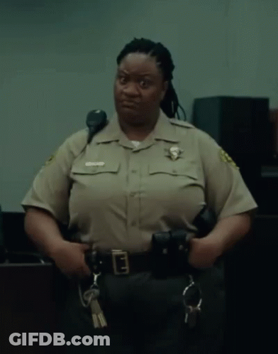 A Woman In A Sheriff 'S Uniform Holds A Pair Of Handcuffs And A Pair Of Keys GIF