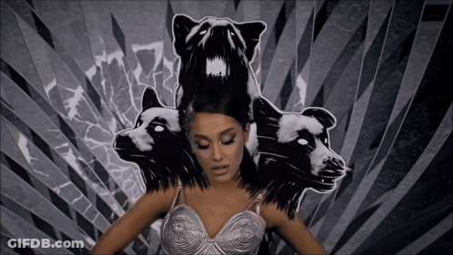 A Woman In A Silver Bra Is Surrounded By Black And White Drawings Of Animals GIF