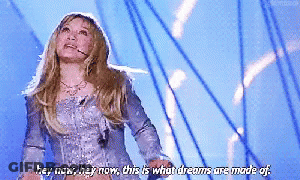 A Woman In A Silver Dress Says Hey Now Hey Now This Is What Dreams Are Made Of .. GIF
