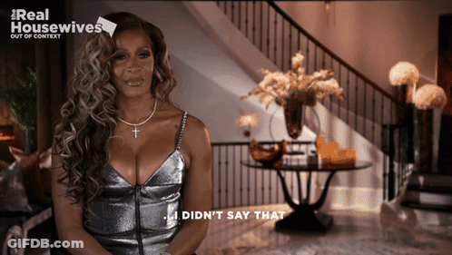A Woman In A Silver Dress Says I Did N't Say That In Front Of A Staircase GIF
