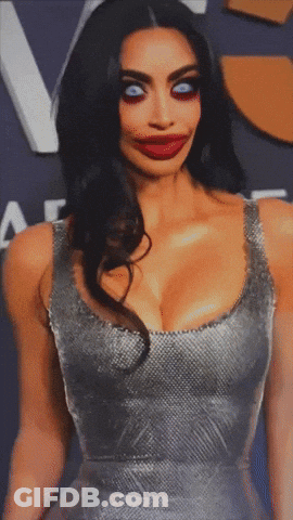 A Woman In A Silver Dress With A Big Red Lip Looks Very Strange GIF