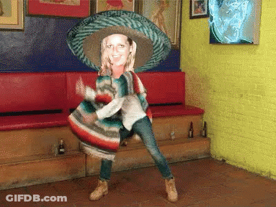 A Woman In A Sombrero And Poncho Is Dancing GIF