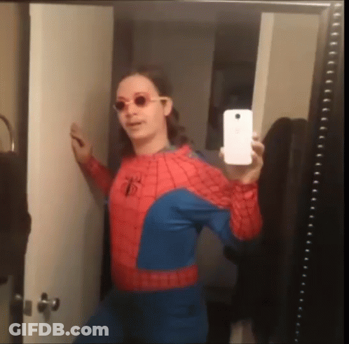 A Woman In A Spiderman Costume Takes A Selfie GIF