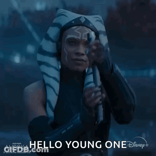 A Woman In A Star Wars Costume Is Holding A Light Saber And Saying Hello Young One GIF