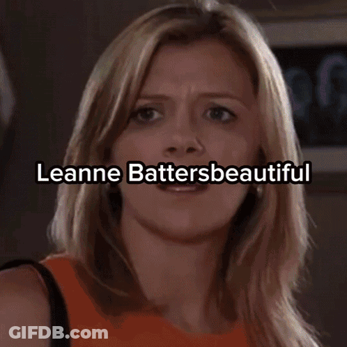 A Woman In A Strapless Dress Holds A Soap Award GIF