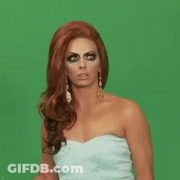 A Woman In A Strapless White Dress Is Making A Funny Face . GIF