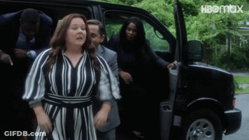 A Woman In A Striped Dress Is Getting Out Of A Van With Hbomax Written On The Bottom GIF