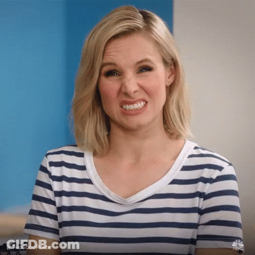 A Woman In A Striped Shirt Is Making A Face . GIF