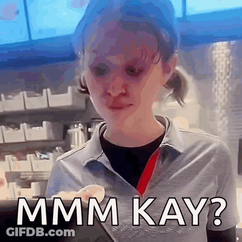 A Woman In A Striped Shirt Is Making A Funny Face And Says Mmmm Kay ? GIF