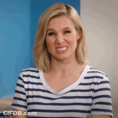 A Woman In A Striped Shirt Is Making A Funny Face . GIF