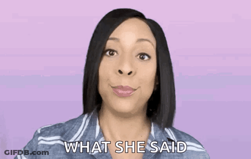 A Woman In A Striped Shirt Is Smiling And Asking What She Said . GIF