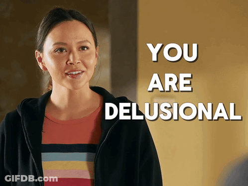A Woman In A Striped Shirt Is Standing In Front Of A Sign That Says " You Are Delusional " GIF