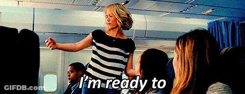 A Woman In A Striped Shirt Says I 'M Ready To On An Airplane GIF