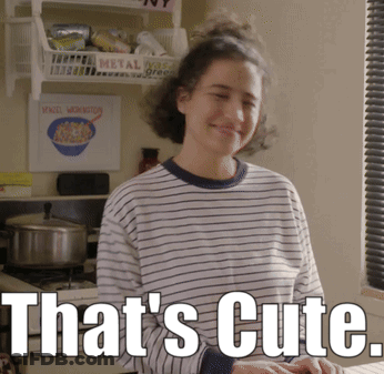 A Woman In A Striped Shirt Says That 'S Cute In White Letters GIF