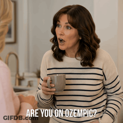 A Woman In A Striped Sweater Is Holding A Cup Of Coffee And Says Are You On Ozempic GIF
