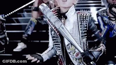 A Woman In A Studded Jacket Holds A Metal Bat GIF