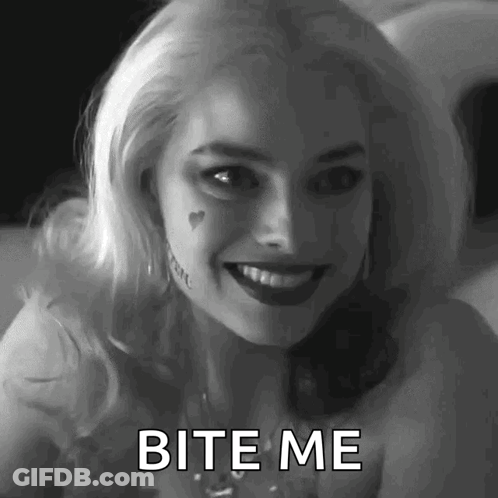 A Woman In A Suicide Squad Costume Is Smiling And Says Bite Me . GIF