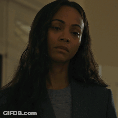 A Woman In A Suit And A Grey Shirt Says Yes GIF