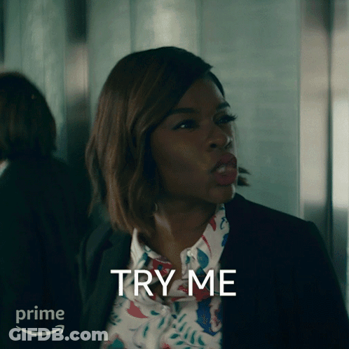 A Woman In A Suit And Floral Shirt Says Try Me In Front Of A Prime Logo GIF