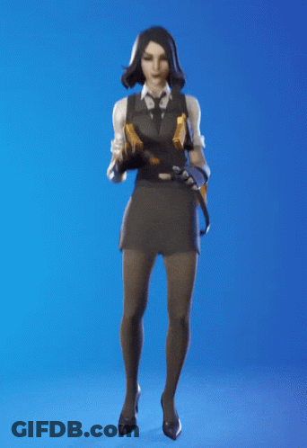 A Woman In A Suit And Tie Is Dancing With Her Hands In The Air GIF