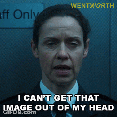 A Woman In A Suit And Tie Is Standing In Front Of A Sign That Says Staff Only GIF