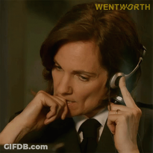 A Woman In A Suit And Tie Is Wearing A Headset With The Word Wentworth On The Bottom GIF