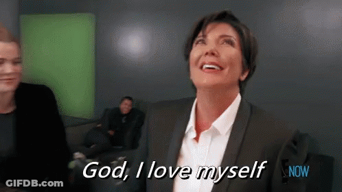 A Woman In A Suit And White Shirt Is Smiling And Saying God , I Love Myself . GIF