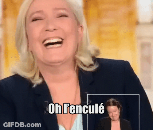 A Woman In A Suit Is Laughing With The Words Oh L'encule Below Her GIF
