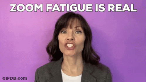 A Woman In A Suit Is Making A Funny Face In Front Of A Purple Background And The Words Zoom Fatigue Is Real . GIF