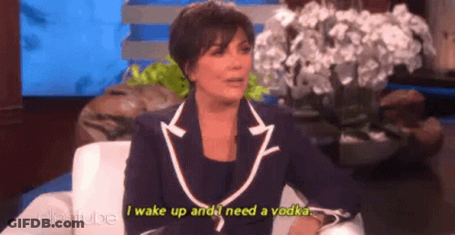 A Woman In A Suit Is Sitting In A Chair On A Talk Show And Talking About A Vodka . GIF