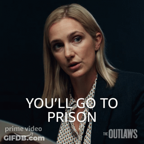 A Woman In A Suit Says " You 'Ll Go To Prison " In White Letters GIF