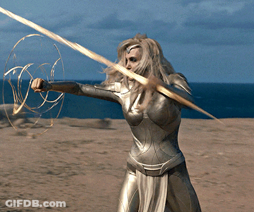 A Woman In A Superhero Costume Holds A Golden Sword GIF