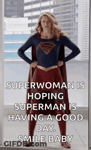A Woman In A Superhero Costume Is Standing In Front Of A Window With Her Hands On Her Hips . GIF