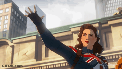 A Woman In A Superhero Costume Is Waving Her Hand In Front Of A Building GIF