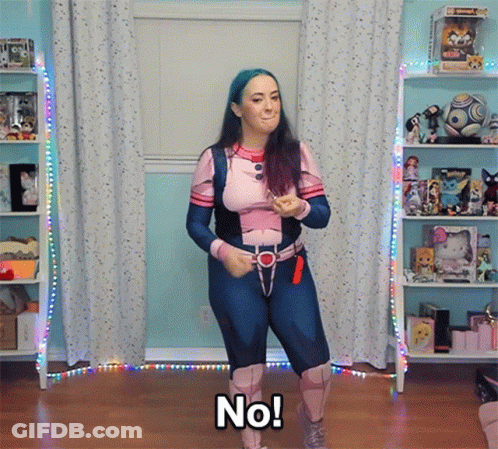 A Woman In A Superhero Costume Says No While Dancing GIF