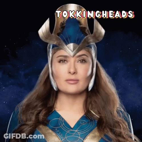 A Woman In A Superhero Costume With The Words Talkingheads On The Bottom GIF