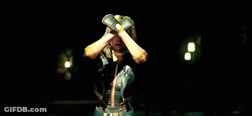 A Woman In A Superhero Outfit Is Screaming With Her Mouth Open GIF