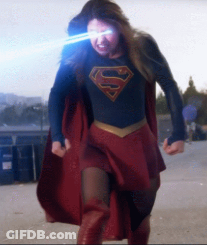 A Woman In A Superman Costume With The Letter S On Her Shirt GIF