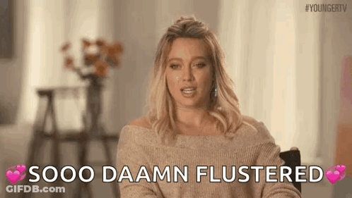 A Woman In A Sweater Is Sitting In A Chair And Says `` Sooo Daamn Flustered '' . GIF
