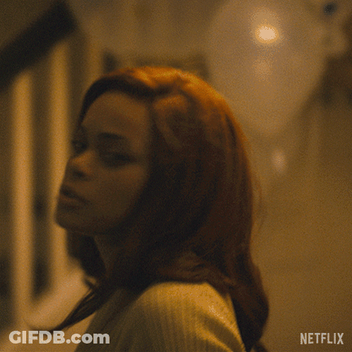 A Woman In A Sweater Says " Never " In White Letters GIF