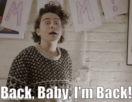 A Woman In A Sweater With The Words Back Baby I 'M Back GIF