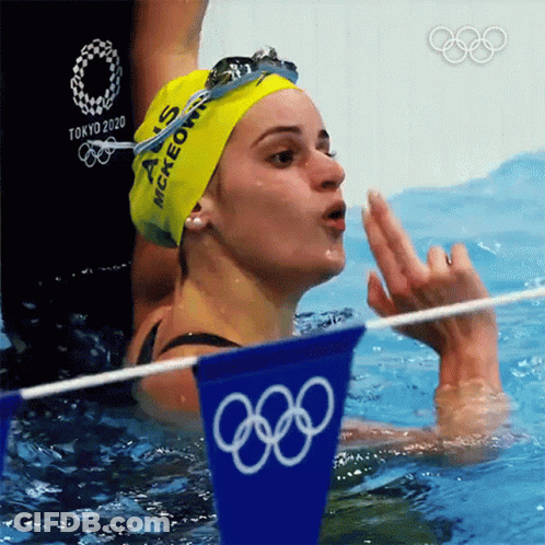 A Woman In A Swimming Pool Wearing A Yellow Cap That Says Mckeown On It GIF