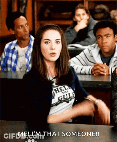 A Woman In A T-Shirt That Says Hell On The Gulf Is Sitting In A Classroom With Other People GIF
