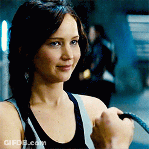 A Woman In A Tank Top Is Holding A Rope GIF