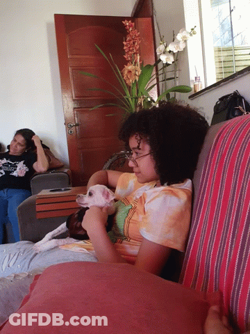 A Woman In A Tie Dye Shirt Is Petting A Small White Dog GIF