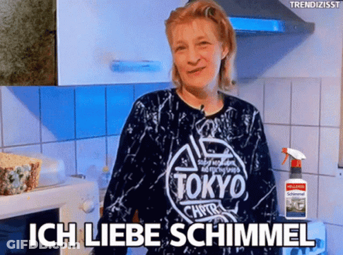 Woman In Tokyo Shirt Standing In Kitchen GIF