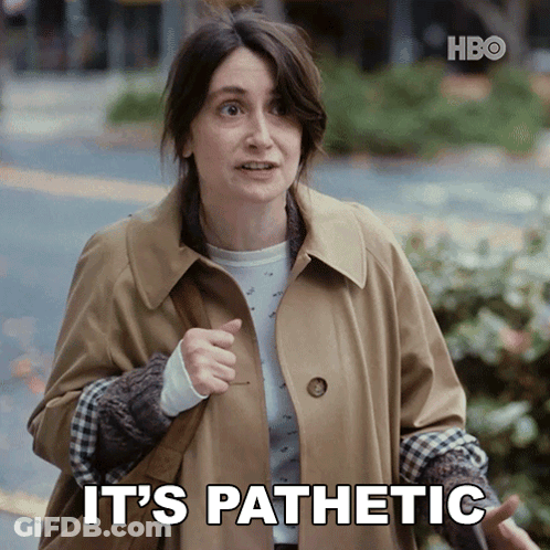 A Woman In A Trench Coat Says It 'S Pathetic While Pointing GIF