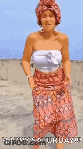 A Woman In A Turban Is Dancing On A Rooftop . GIF